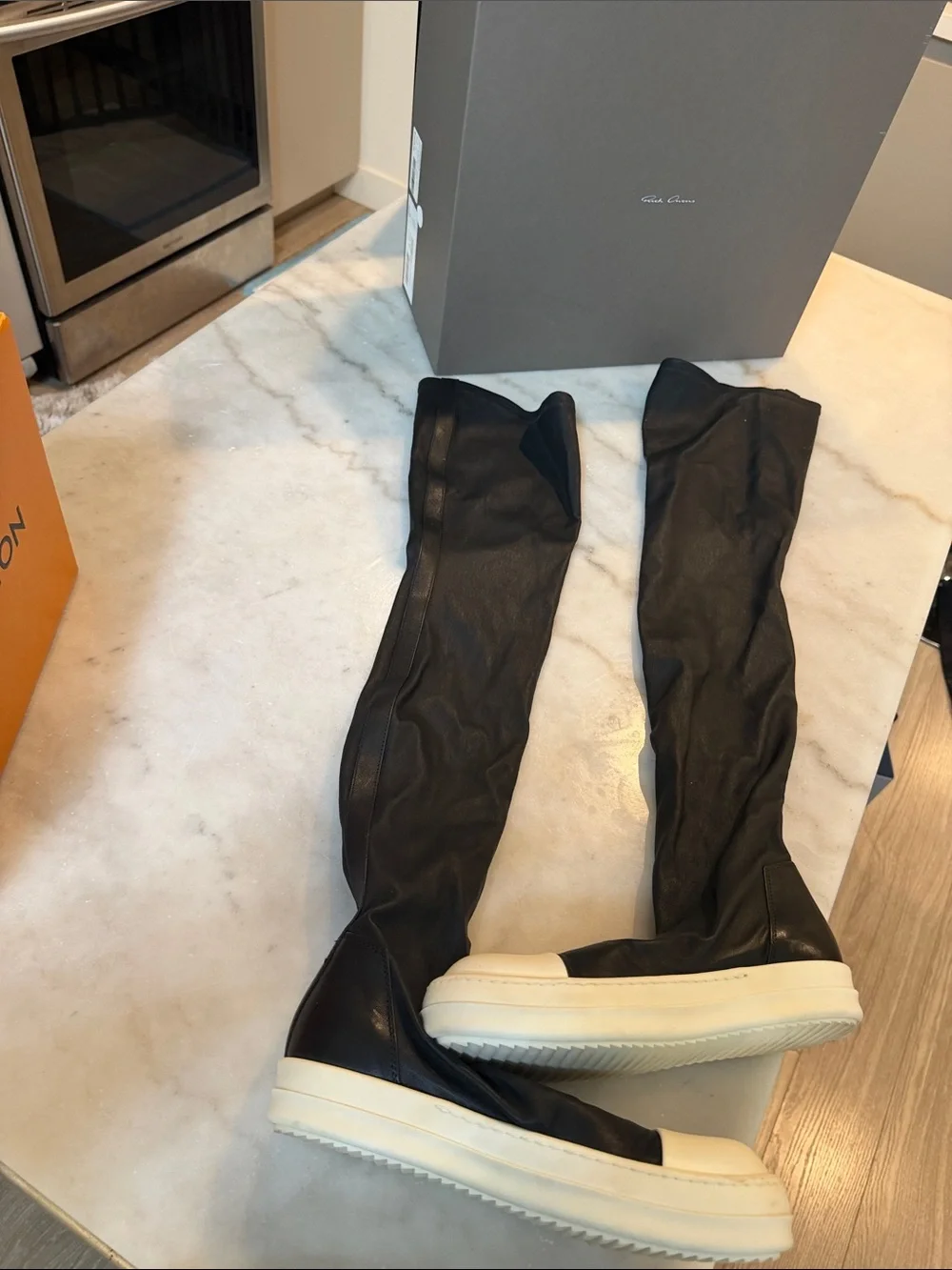 Rick Owens black knee-high boots with white platform sole